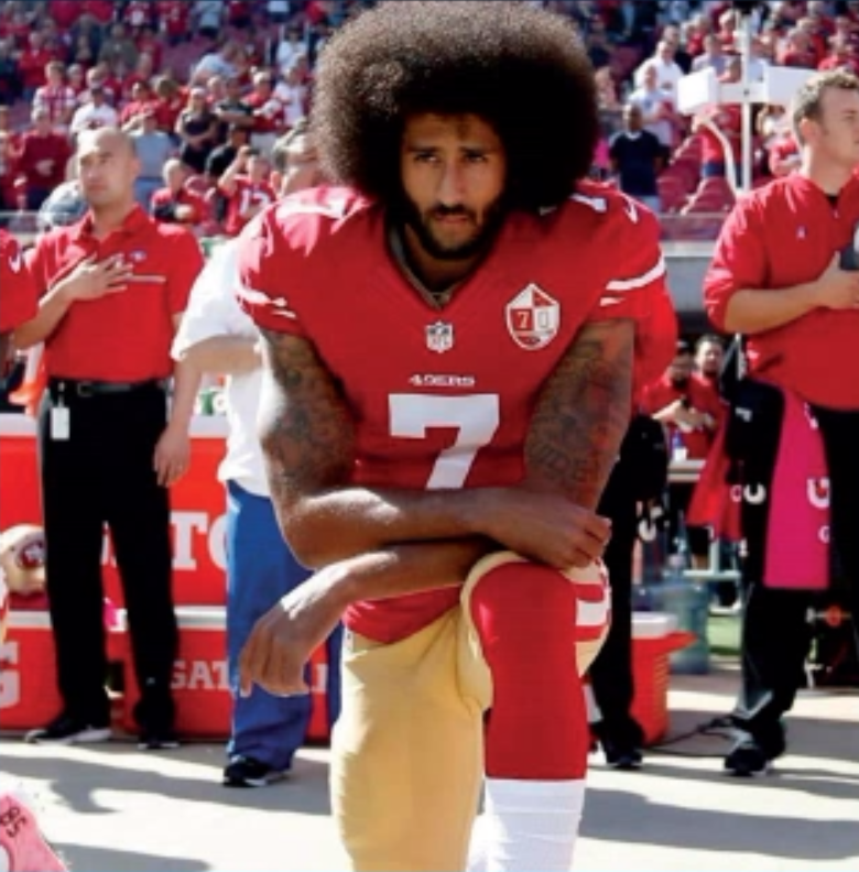Kaepernick+kneels+before+a+San+Francisco+49ers+game.Before+leaving+the+NFL+Kaepernick+led+the+team+to+a+super+bowl+victory+in+in+2012.