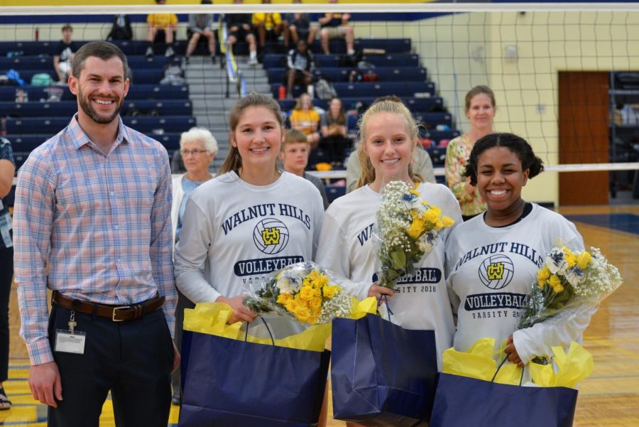 SENIORS          Holly Bates, Stephanie Carson and Arden Miller (right to left) are congratulated by their coach Nick Toth on Senior night. Senior night represents the last game these SENIORS will ever play at WHHS.