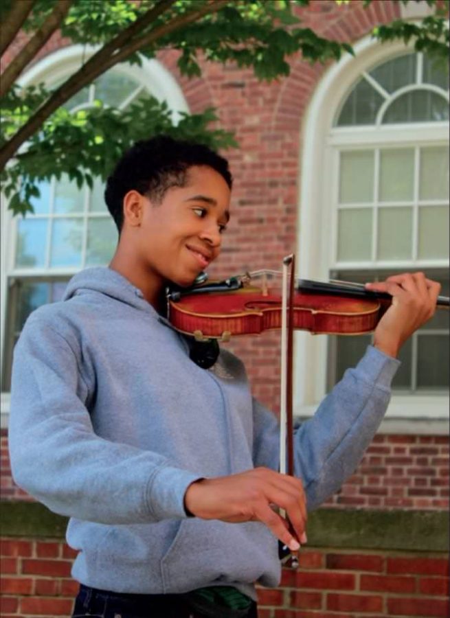 Maxwell Fairman, ‘22, poses with his violin at WHHS. Fairman started performing at four years old and goes through rigorous preparation for any competition or performance coming his way.