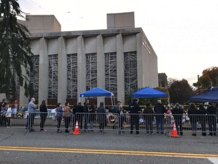 People pay their respects at a memorial to the victims of a mass shooting in front of the Tree of Life, or LSimcha, Congregation in Pittsburgh, Penn.  On Oct. 27, 10 congregants were shot at the synagogue.
