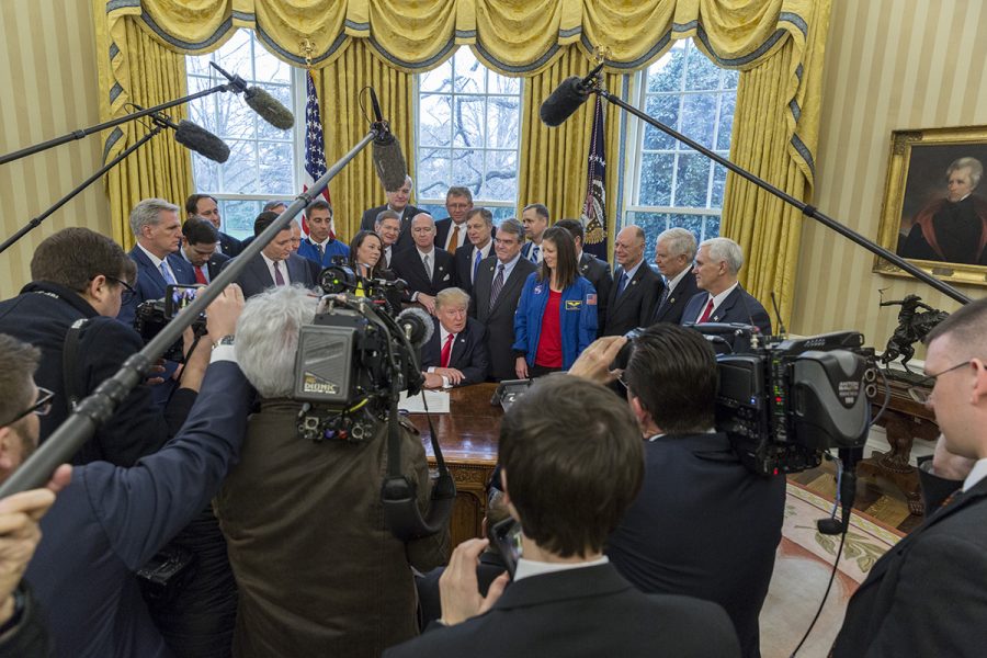 President Donald Trump talks to press, March 21, before signing the National Aeronautics and Space Administration Transition Authorization Act in the Oval Office.