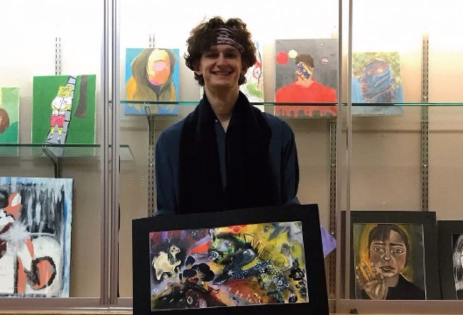 SENIOR Arthur Schmid stands above with one of his award-winning pieces from the Scholastic Art Awards. The Awards are being shown in the Art Academy of Cincinnati through Feb. 8.