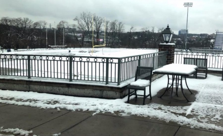 Snow and ice cover the plaza outside the Arcade and the football field. Several times already this year, students and faculty have had to walk through these conditions to enter the school. 