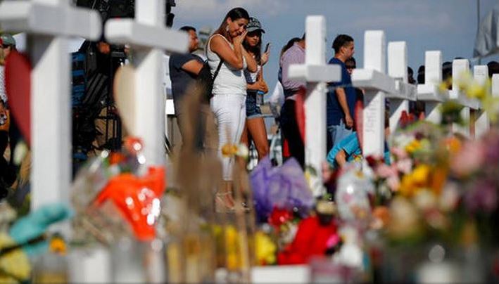 Mourners stand in front of a memorial for the victims of the August 3 shooting in El Paso, Texas. A day later, on August 4, there was another mass shooting in Dayton, Ohio.