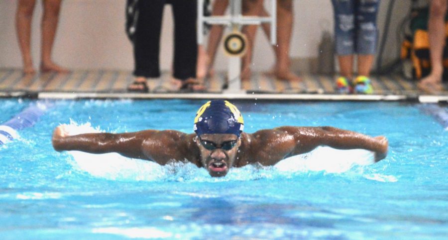 Barry Bates, ‘21, swims butterfly at a meet at WHHS. Bates honed the skill at practice. “Swimming really depends on how much the swimmer wants to get out of practices ... but all comes together with the team in the end too,” Sakura Adachi, ‘23, said. 