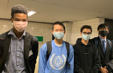 SENIORS Alan Zhang and Meoshea Britt stand alongside Justin Chan, ‘22, and Sanjay Luckwitz, ‘21, while waiting for the next train on the Green Line light rail. The students wore face masks while traveling in Boston, Mass. to minimize the chances of them contracting the Wuhan Coronavirus. 