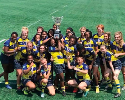 The WHHS women’s rugby team poses with their trophy after defeating St. Joseph Academy from Cleveland.