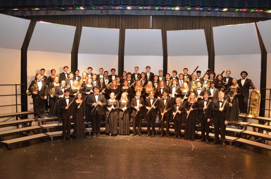 The 2018-2019 WHHS Wind Ensemble pose on the stage where they performed several concerts. The Wind Ensemble was included in the senior high band concert on Feb. 25, 2020.