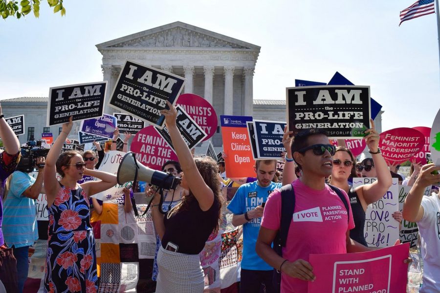 Both pro-life and pro-choice protestors gather outside the Supreme Court in 2016. The demonstration protested the landmark decision of Whole Woman’s Health vs Hellerstedt. The Court ruled that Texas could not put restricitons on abortion services to prevent women from seeking an abortion. 
