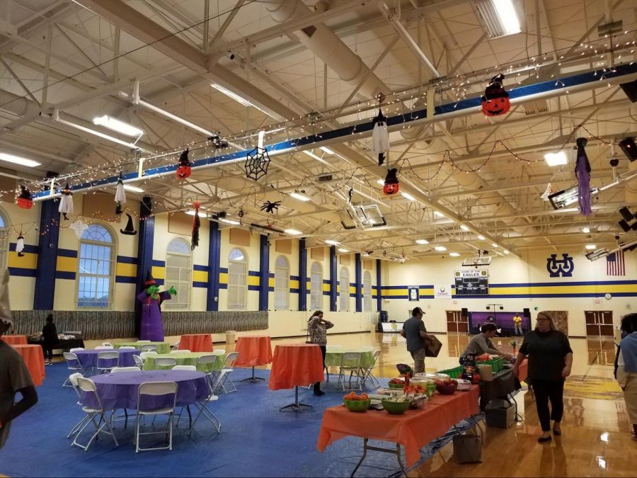 Volunteers set up last year’s boogie bash in the WHHS Gymnasium. The Boogie Bash has been a way for seventh and eighth graders to get creative and celebrate Halloween with their fellow classmates. This year, due to COVID-19, the Boogie Bash has been moved online.  