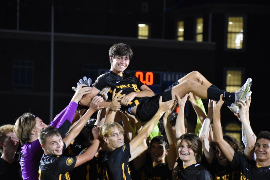 Sophmore Roman Girandola being lifted up by his teammates in celebration of a win