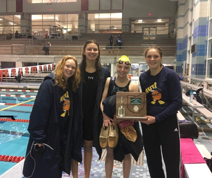 Annalise Smith ‘23, SENIOR Phoebe Wright, SENIOR Ava Stallmeyer, and Angelina DiPaulo ‘24 pose with the second place trophy the WHHS girls swim and dive team won at the Southwest Ohio District championship. 
