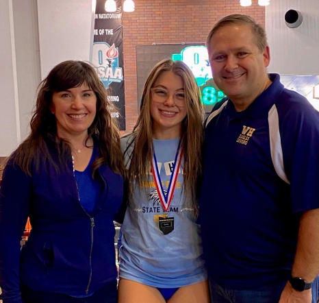 Bela Noble embraces her parents after capturing her state championship
in the division 1 girls one meter diving with a score of 491.8. “After seeing my final score I was ecstatic to see that I had beaten all the scores I had throughout the season,” said Noble.