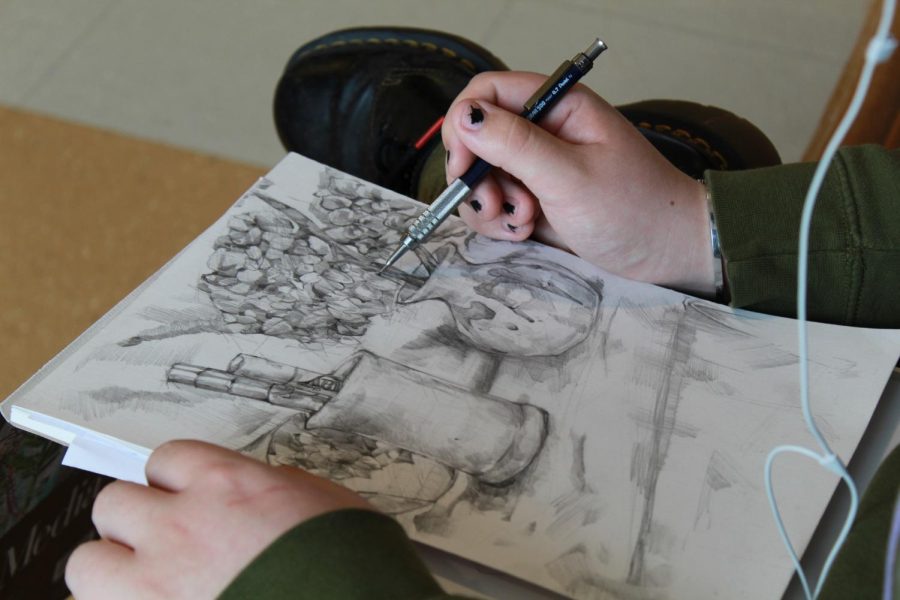 SENIOR Arlo Grimaldi works on a new still life drawing which is any picture including natural objects such as fruits, flowers, or vegetables for the purpose of celebrating material pleasures.