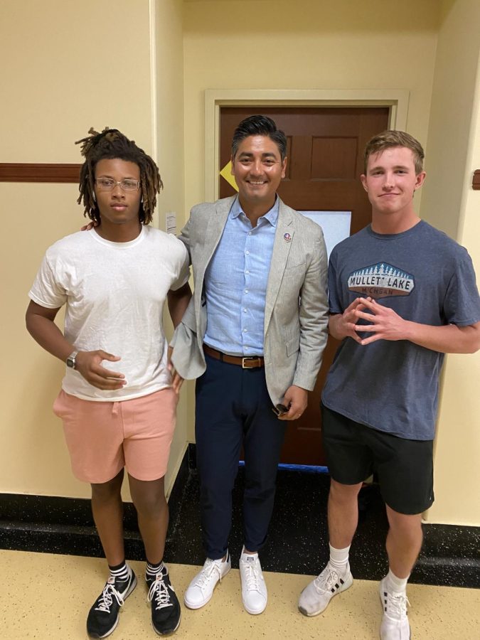 Students Langston McGhee, ‘23, and SENIOR Ryan Vogt take a photo with Mayor Aftab Pureval, following their forum-like discussion. 