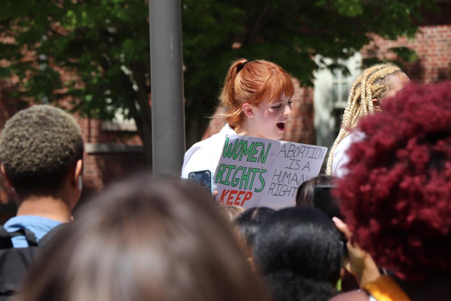 Max Shawhan, ‘23 attends the walkout on May 17 to protest for abortion rights. While speaking out, Shawhan holds a sign stating, “Abortion is a human right,” 