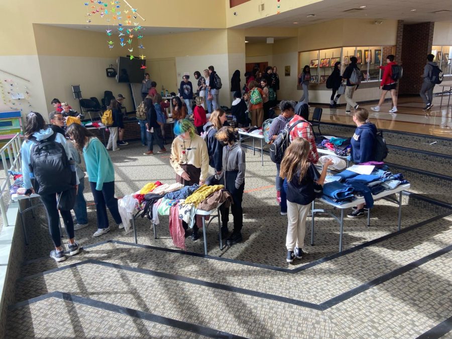 Multiple students look through the donated Thrift Shop clothes in the forum. Many enjoyed browsing and buying clothes, earning Boo Radley and fashion club $200 for fundraising. 
