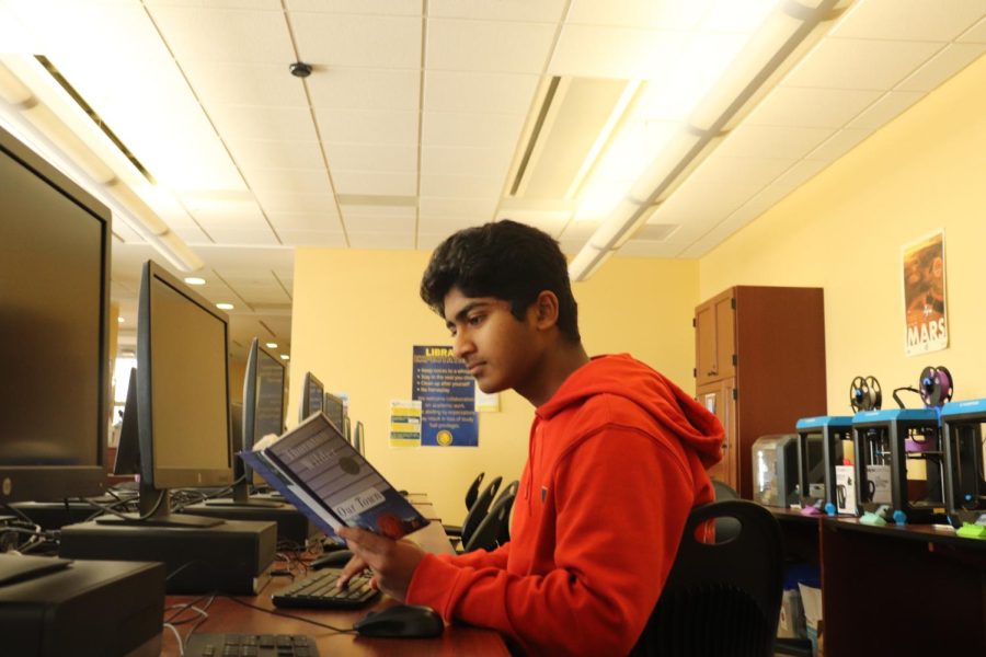 Akhilesh Ponna, 26’, reads a book in the computer lab. Students do not have to use the computers to be in the computer lab.