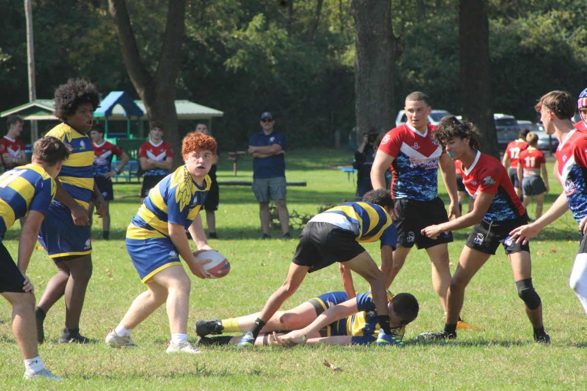 Archer Dunn, '28, is passing the ball out to his teammate at the Dayton Rugby Grounds on Oct. 6. 