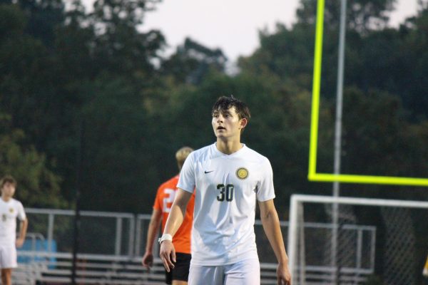 Daniel Min prepares to defend an Anderson free kick in a crucial ECC conference game.
