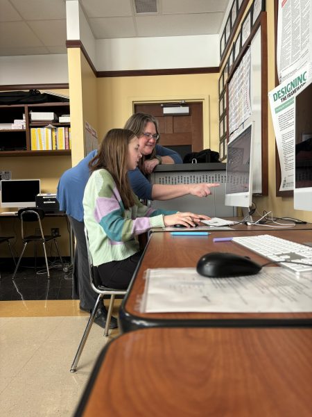 Elena Brown, ‘27, and Samantha Gerwe-Perkins look over a story document toegher in the J-lab. Brown had Gerwe-Perkins as a teacher for news writing in seventh grade, then news production in eighth and ninth grade.