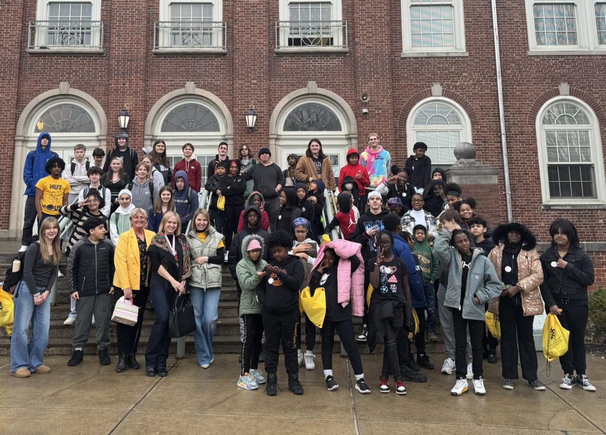 WHHS and AWL student participants of the Russian Pen-Pal Project stand on the steps of the Blair Circle entrance. As they stood, it began to snow on the group.
