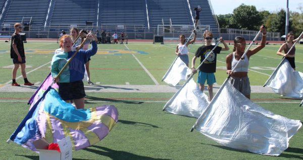 Members of the color guard fine-tune their skills after school on Marx Field in preparation for their first competition of the year. “I am looking forward to really getting into the nitty gritty details and editing things to make it better,” rookie Alexa Beaver said.