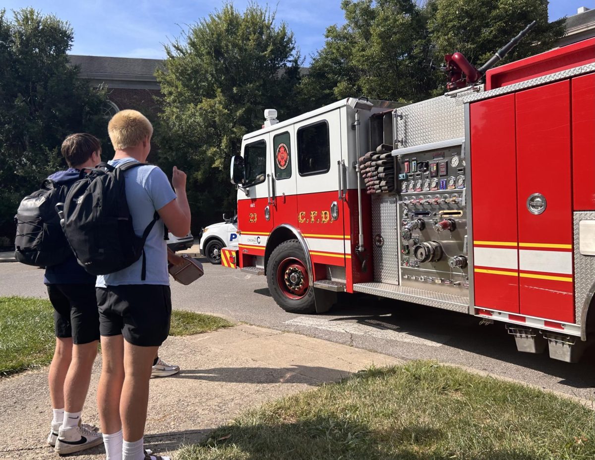 Students inspect fire trucks as they drive past Blair Circle.