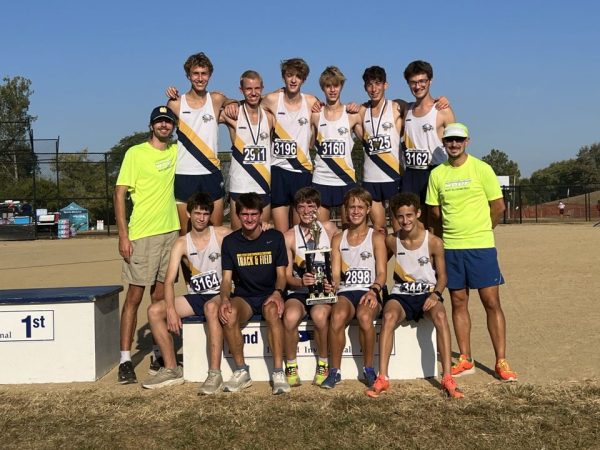 Awarded with second place in their race division, the cross country varsity boys rejoice.