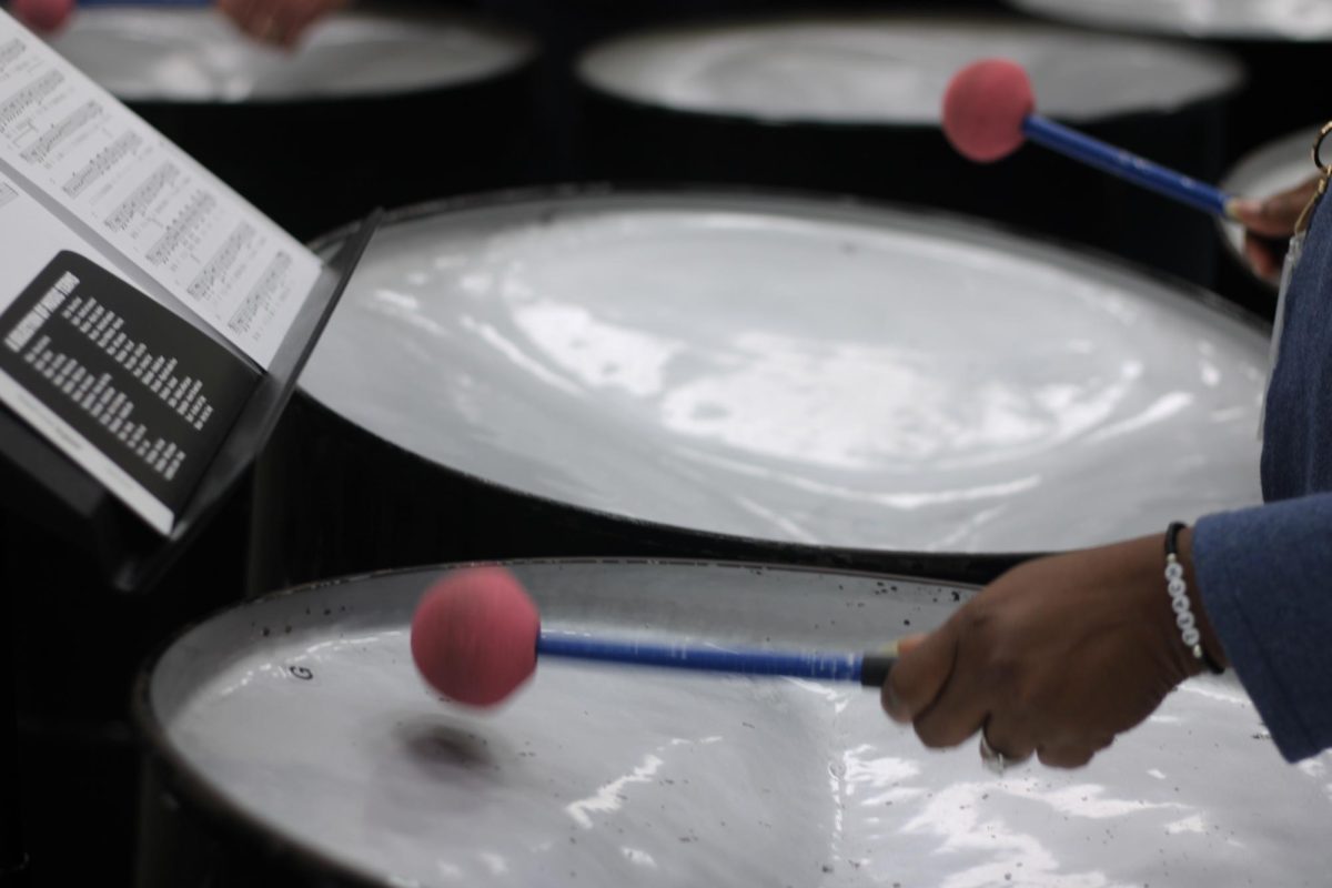 Science teacher Debra Hutchinson plays the steel drum during a faculty steel drum band practice.