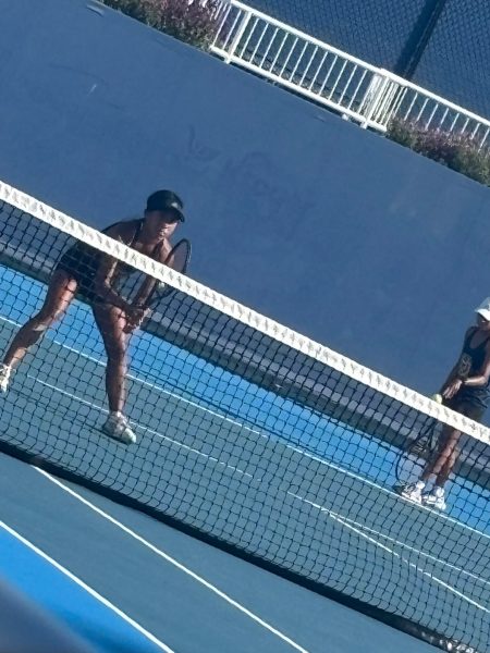 Irisa on the right serving the ball plans to not continue tennis after college and Perasa on the left plans to play tennis in college.
