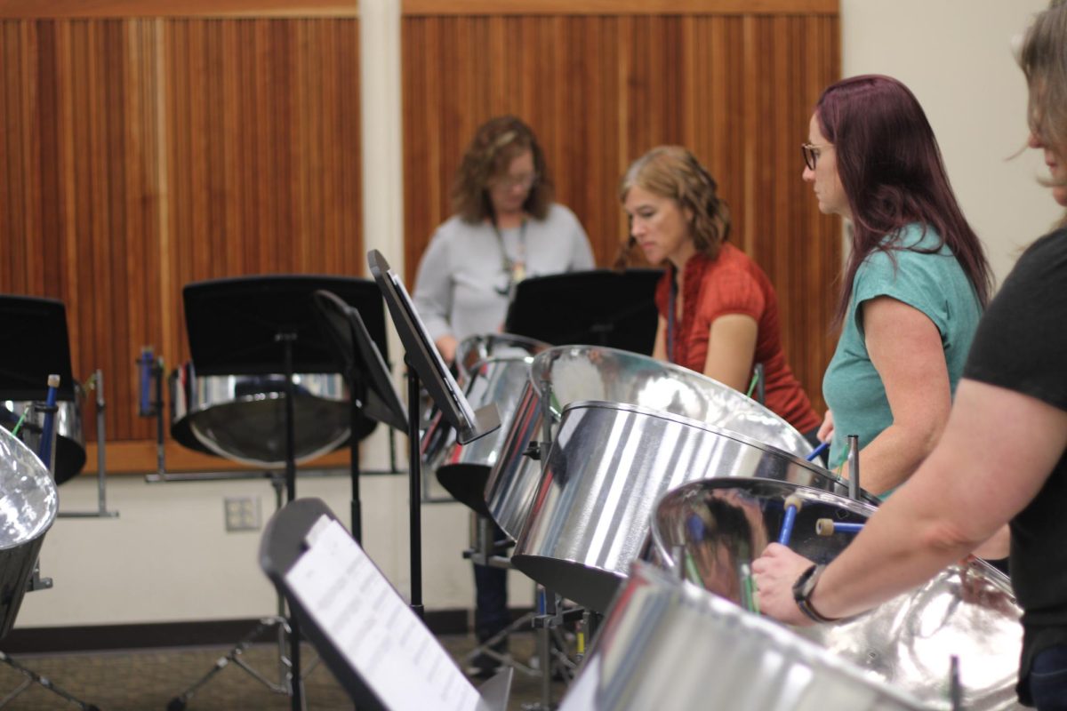 Laurie Cotton, math teacher, and Shannon Montiel, Spanish teacher jam out during an early morning practice. "“I think it's the highlight of my school week," Montiel said. "We don't want to stop, we want to keep going."