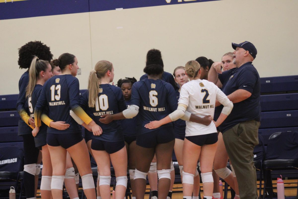 The womens' varsity volleyball team prepares for a game.